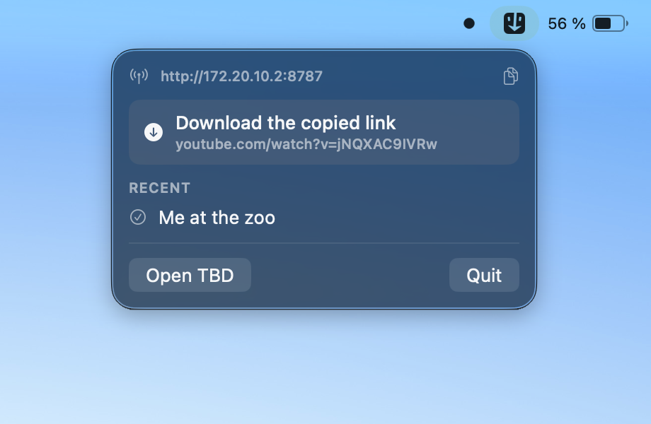 The TBD menu bar item open on macOS, showing a download in progress above the desktop.